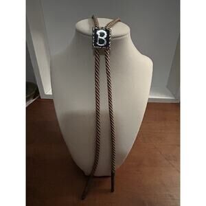 vintage bolo tie featuring a silver-tone initial "B"